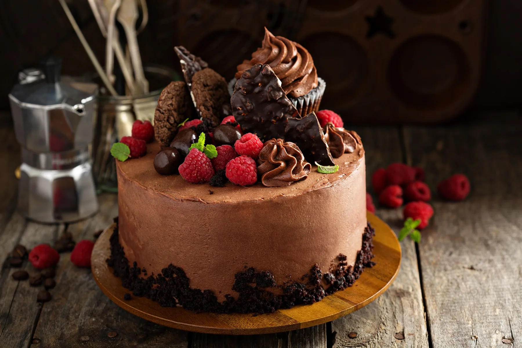 Premium chocolate cake decorated with raspberries and chocolate