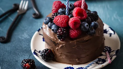 Chocolate cake topped with raspberries, blueberries and blackberries